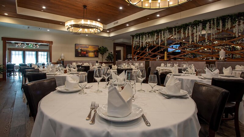 Main dining room with many set tables with white table cloths